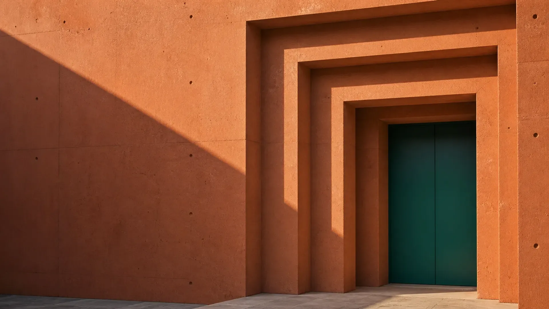 Nested terracotta frames stepping inward around a protected teal door