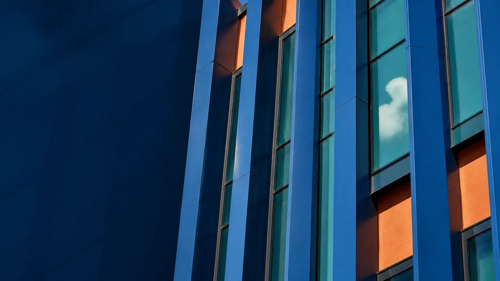 A modular facade grid of cobalt window bays