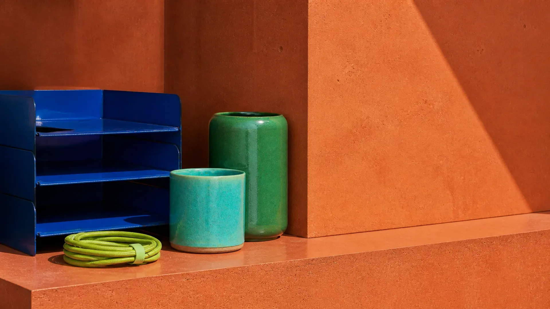 A cobalt shelf with green vessels in bright side light