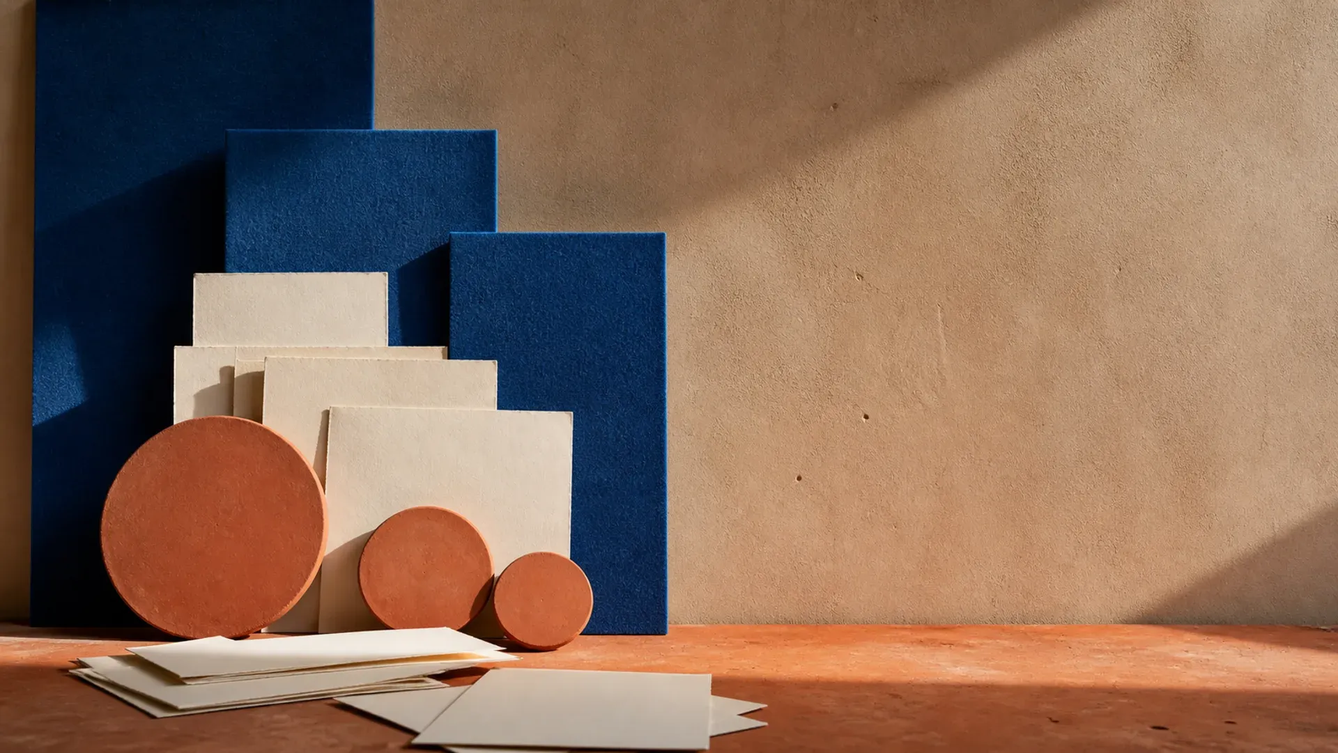 Overlapping frames and layered panels in terracotta and cobalt