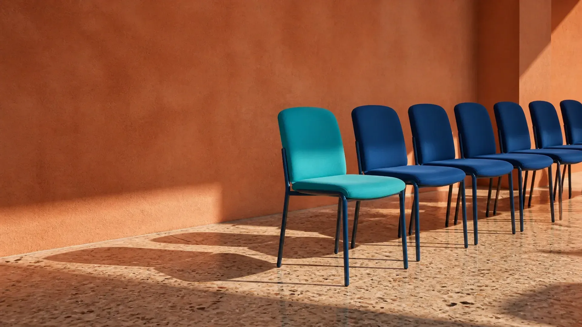 A row of chairs with one seat offset, waiting to be filled